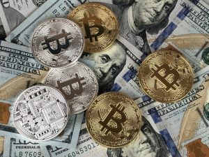 hundred-dollar-bills-and-bitcoin-coins_800